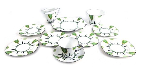 A Royal Stafford bone china part tea service, decorated in a Clarice Cliff style with stylised trees, comprising one tea cup and saucer, milk jug, sugar bowl, bread plate and six side plates.