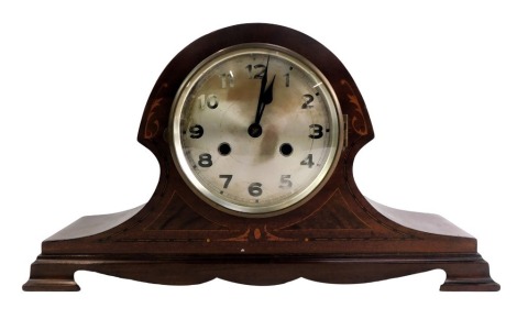 An Edwardian mahogany cased mantel clock, the silvered numeric dial with black hands, an eight day movement with coil strike, with boxwood inlay, on a shaped foot, 26cm high, 40cm wide, 12cm deep.