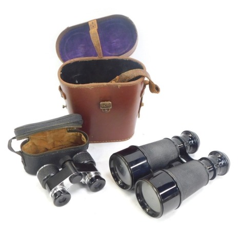 Two pairs of binoculars, comprising a pair of French Naval Military binoculars, in leather case, and a pair of folding Empire opera glasses. (2)