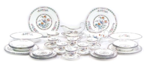 A Wedgwood Kutani Crane pattern part tea and dinner service, comprising teapot, sauce boat and saucer, milk jug, sugar bowl, six cups and saucers, six side plates, six small plates, six dinner plates, six medium plates, and two oval serving tureens.