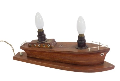 A 20thC table lamp modelled as a wooden boat, 44cm wide.Buyer Note: WARNING! This lot contains untested or unsafe electrical items. It is supplied for scrap or reconditioning only. TRADE ONLY 