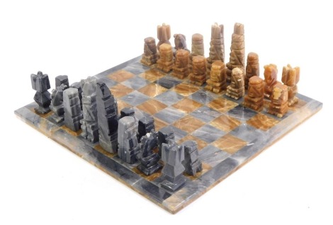 A marble chess set and board, the board 38cm x 38cm.