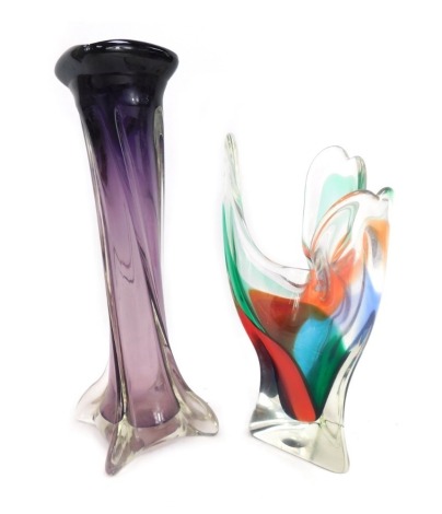 Two items of 20thC glass, comprising an amethyst glass twist stem vase, 33cm high, and a three-fold multicoloured vase, 26cm high. (2)