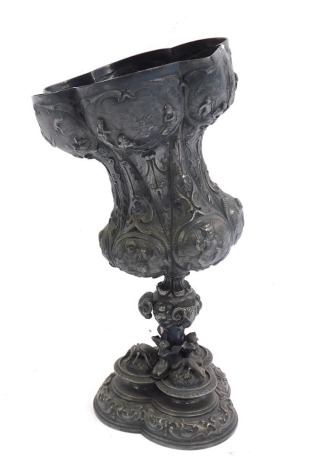 A 20thC silver plated vase, of waisted form, embossed with reserves of figure groups and Putti, raised on a stem cast with ram's heads, on a trefoil base cast with winged figures, a lizard, a serpent and a scarab beetle, with rococo scrolls, 21cm high. (A