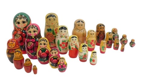 A group of painted wooden Matryoshka Russian dolls, signed, the largest 7cm high, the smallest 5cm high.