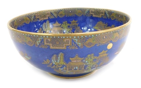 A Carlton ware Kang Hsi pottery lustre bowl, on a blue ground with gilded decoration, 20cm diameter.