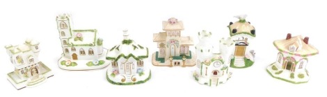 Seven Coalport ceramic cottages, comprising Village Church, The Villa, Tyrolean Castle, Dovecote, Castle, Thatched Cottage, and The Gatehouse, the largest 13cm high. (7)