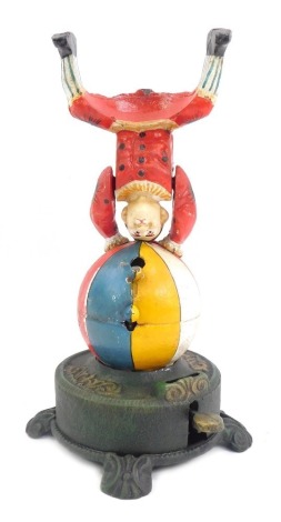 A novelty cast iron money box, depicting a clown on a balloon, on a circular base, 30cm high.