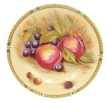 An Aynsley Fruits of Bloom cabinet plate, in the Autumn Gold pattern with gilt border, signed D Jones, 26cm diameter.