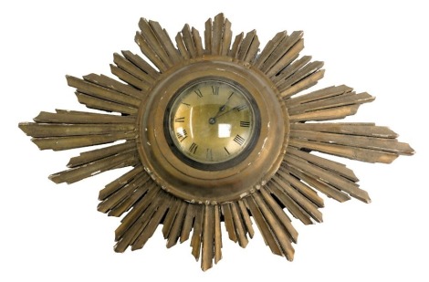 An early 20thC gilt wood wall sunburst clock, circular brass dial bearing Roman numerals, with clockwork movement, 50cm high.