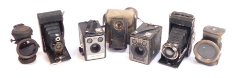 A group of cameras, including a Kodak Brownie SIX20 camera, a further Kodak Box Brownie, and a Zeiss Ikon folding camera, together with a police night lamp and two cycle lamps. (1 tray) (AF)