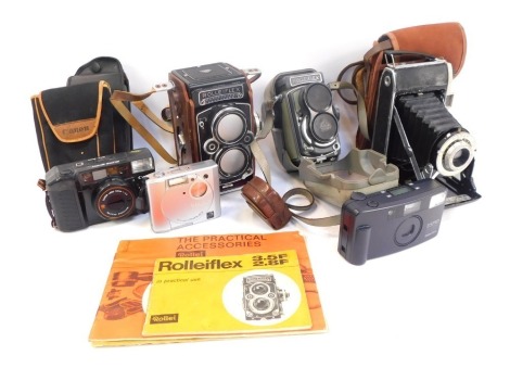 A group of vintage camera equipment, including a Rollaflex camera, a Pentax SPO camera, Canon, and others. (1 tray)