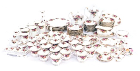 An extensive group of Royal Albert Old Country Roses tea and dinner wares, including a wall clock, oval meat plate, three tier cake stand, milk jug, coffee pot, teapot, twelve teacups, six coffee mugs, shoes, ornamental shoes, butter knife, six dinner pla