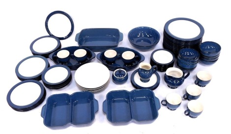 A Denby Imperial Blue part tea and dinner service, including three ramekins, two sectional ovenware dishes (x2), ten dinner plates, ten side plates, three medium plates, one large serving bowl, eight bowls, a milk jug, a sugar bowl, eight teacups, a small