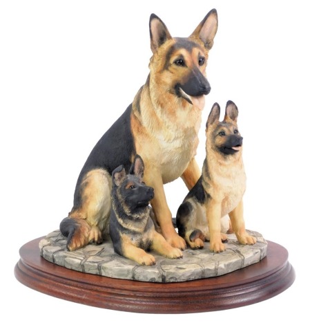 A Border Fine Arts German Shepherd and pups figure group, BO351, c1998, with wooden oval stand, 29cm high, 30cm wide.