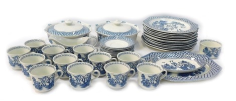 A J & G Meakin pottery part dinner service in the Willow pattern, comprising a meat plate, two tureens and covers, a gravy boat and saucer, ten dinner plates, twelve tea cups and saucers, and a sugar bowl.