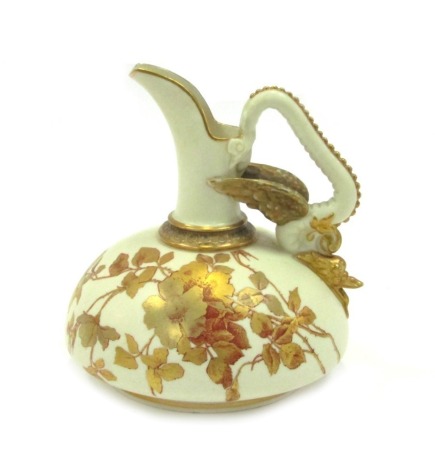 A Royal Worcester jug decorated in the Purple Marjorie pattern, of oval shaped with blush ivory ground, with gilded floral and fish moulded decoration, with purple Worcester stamp to underside, No 1048, 16cm high.