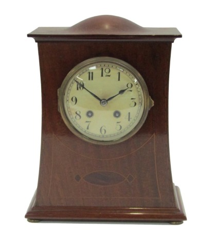 A mid 20thC mahogany cased Art Nouveau style mantel clock, the shaped and domed top with boxwood inlay, with a white enamel numeric dial, on bun feet, 30cm high, 25cm wide, 12cm deep.