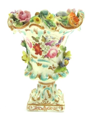 A Coalport urn, with a floral raised design picked out in gilt, stamped Coalport, 13cm high.