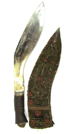 An Eastern Kukri, with a curved blade, in a velvet and wooden lined slipcase with raised floral embroidery, on a shaped handle, 41cm wide.