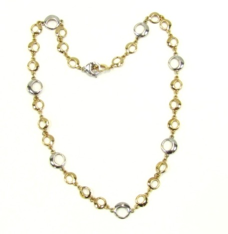 A fancy circular link neck chain, yellow and white metal, on a lobster claw clasp, stamped 9kt, 14.7g.