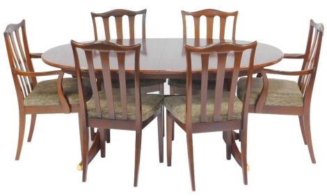 A G-Plan mahogany and crossbanded extending dining table, the oval top raised on two out swept end supports united by a stretcher, with integral leaf, 70cm high, the top 155cm x 103cm, together with six dining chairs, with overstuffed seats (four plus two