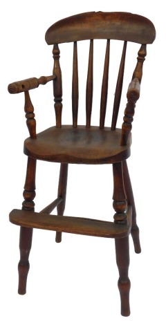 A 19thC elm child's highchair, with spindle back, solid seat, turned legs and footrest, united by H shaped stretcher, 88cm high.