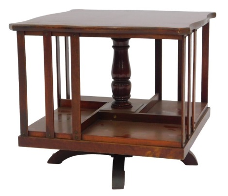 An Edwardian mahogany tabletop revolving bookcase, the square shaped top with four divisions for books, on revolving base with curbed legs, 32cm high, the top 36cm x 36cm.