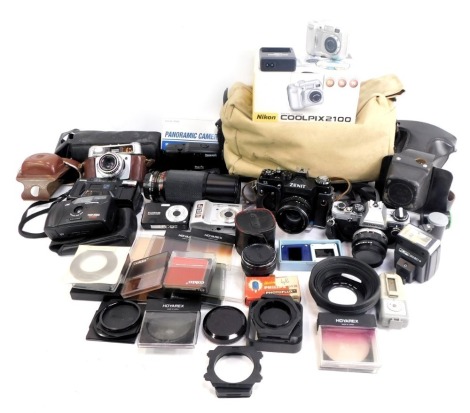 Various cameras and optical equipment, to include a Hanimex Duomatic camera, in leather case, digital cameras, an Olympus OM10 camera, in case, various lenses to include an Elicar macro 75-250mm lens, further equipment, canvas case, etc. (a quantity)