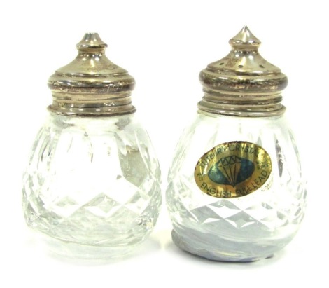 A pair of Tutbury Crystal and silver lidded salt and pepper pots, Birmingham 1998.