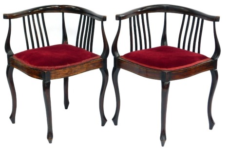 A pair of Edwardian mahogany and boxwood line inlay corner chairs, each with a slatted back with red velvet overstuffed seat, on cabriole legs.