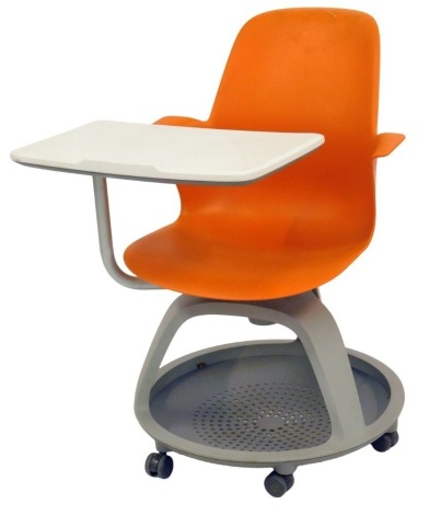 A Node ergonomic classroom chair and desk, the orange moulded plastic chair with swivel desk, on a pierced circular base, on castors, 92cm high.