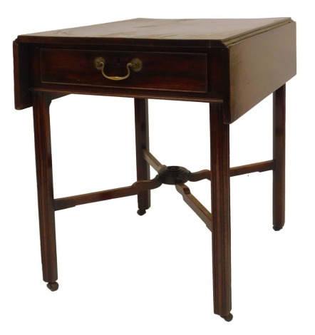 A George III mahogany Pembroke table, with a frieze drawer, on canted legs with castors united by an X-shaped stretcher, 73cm high, 57cm wide, 90cm extended, 72.5cm deep.