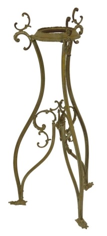 An early 20thC cast brass urn or vase stand, on a triform base with leaf cast feet, 80cm high.