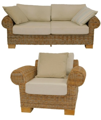 A wicker conservatory suite, comprising two seater sofa and armchair, with loose seats and back cushions.