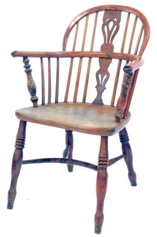 A 19thC yew and elm Windsor chair, with a pierced splat and single back, solid seat, turned legs united by a crinoline stretcher.