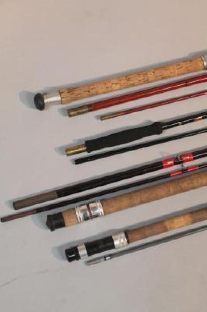 Four fibre glass fishing rods.
