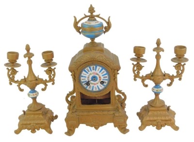 A 19thC French gilt metal and enamelled clock garniture, the white enamel circular dial bearing Roman numerals interspersed with blue sections, floral decoration and gilt highlights, the case surmounted by a porcelain and gilt metal urn, the case elaborat