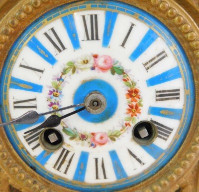 A 19thC French gilt metal and enamelled clock garniture, the white enamel circular dial bearing Roman numerals interspersed with blue sections, floral decoration and gilt highlights, the case surmounted by a porcelain and gilt metal urn, the case elaborat - 4