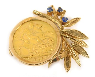 An Edward VII full gold sovereign brooch, dated 1905, the circular brooch with fern spray, set with three sapphires in 9ct mount, 12.3g all in, 3cm wide.