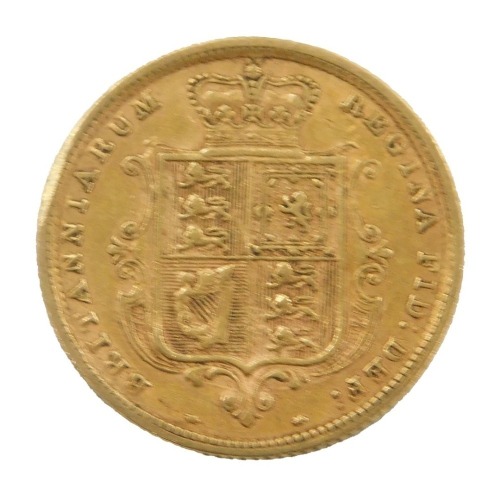 A Queen Victoria shield back half gold sovereign, inverted, dated 1883.