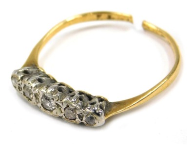 A diamond five stone dress ring, set with five round brilliant cut diamonds, each in a rub over platinum setting, on a yellow metal band, unmarked believed to be 18ct plat, cut, 1.6g all in. (AF)