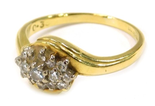 An 18ct gold diamond cluster ring, set with three layers of round brilliant cut diamonds, on twist design ring head, London 1973, ring size P½, 4.2g all in.