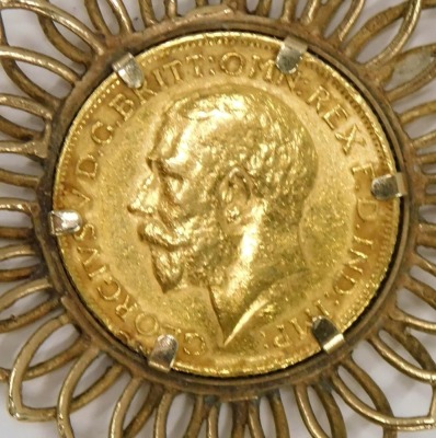 A George V full gold sovereign pendant, dated 1912, in a yellow metal sunflower frame, stamped 375, the pendant 4cm high, on fine link neck chain stamped 375, 44cm long, 15.1g all in. - 2