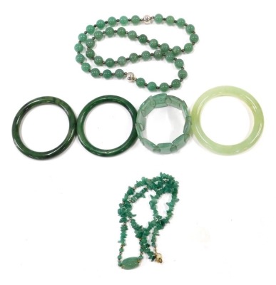 Various jade and imitation jade jewellery, comprising three bangles, necklace and bracelet.