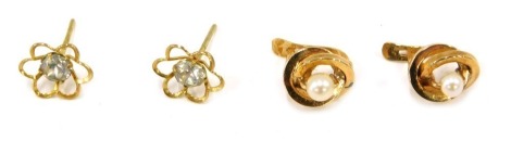 Two pairs of stud earrings, comprising cultured pearl twist stem earrings, yellow metal unmarked, and a pair of paste stone cluster earrings, unmarked, 2.3g all in. (2)