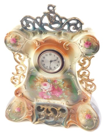 An early 20thC pottery clock case, printed with flowers, etc., mounted with a foreign movement, 46cm high.