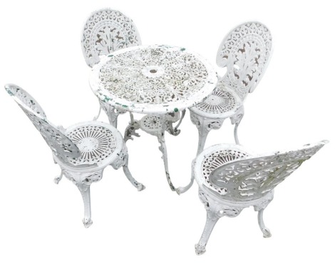 An aluminium cream and green painted garden table and chairs, the circular garden table of pierced floral design, and four associated chairs, 70cm high, 67cm diameter.