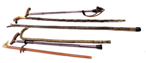 Various walking canes, comprising a brass duck handled walking cane, carved wooden duck walking cane, etc. (a quantity)