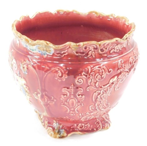 A 20thC planter, on a pink ground with scroll decoration, transfer printed cherub centre, 18cm high.